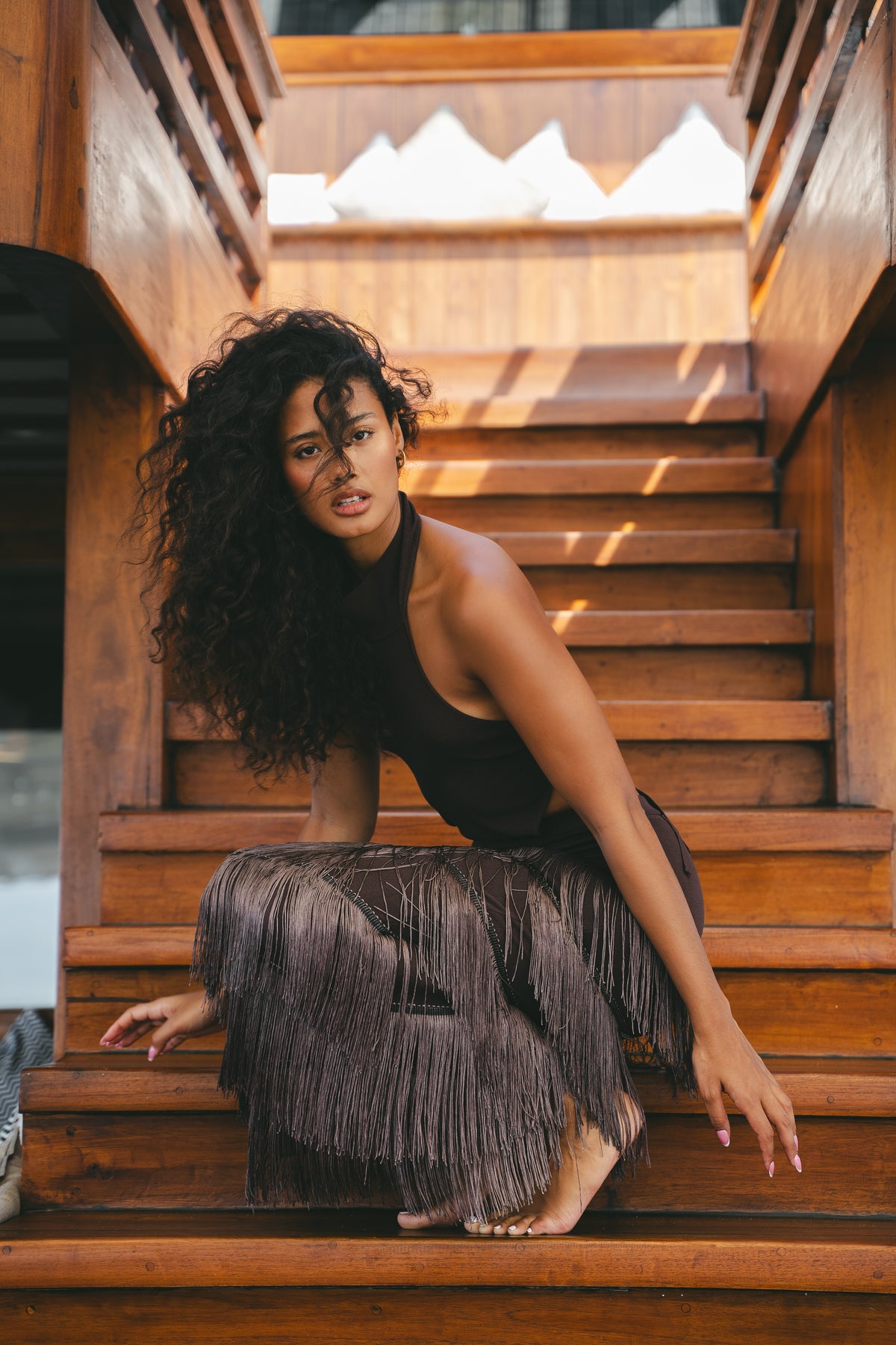 Seated detail of the Halter Fringe Maxi Dress showing the layered fringe in motion