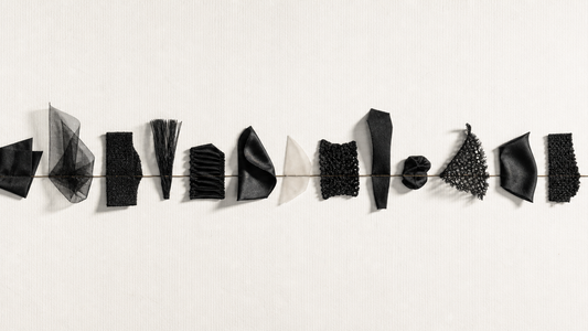 Thirteen distinct textile studies unified along one fine bronze axis