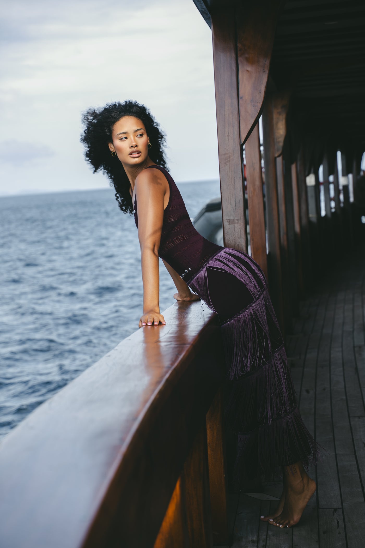 Side view of the mulberry Fringe Knit Maxi Dress showing the tiered fringe and knit structure