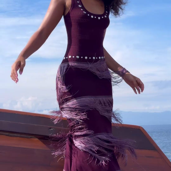 Model walking on a boat deck in the burgundy Fringe Knit Maxi Dress, with fringe in motion.